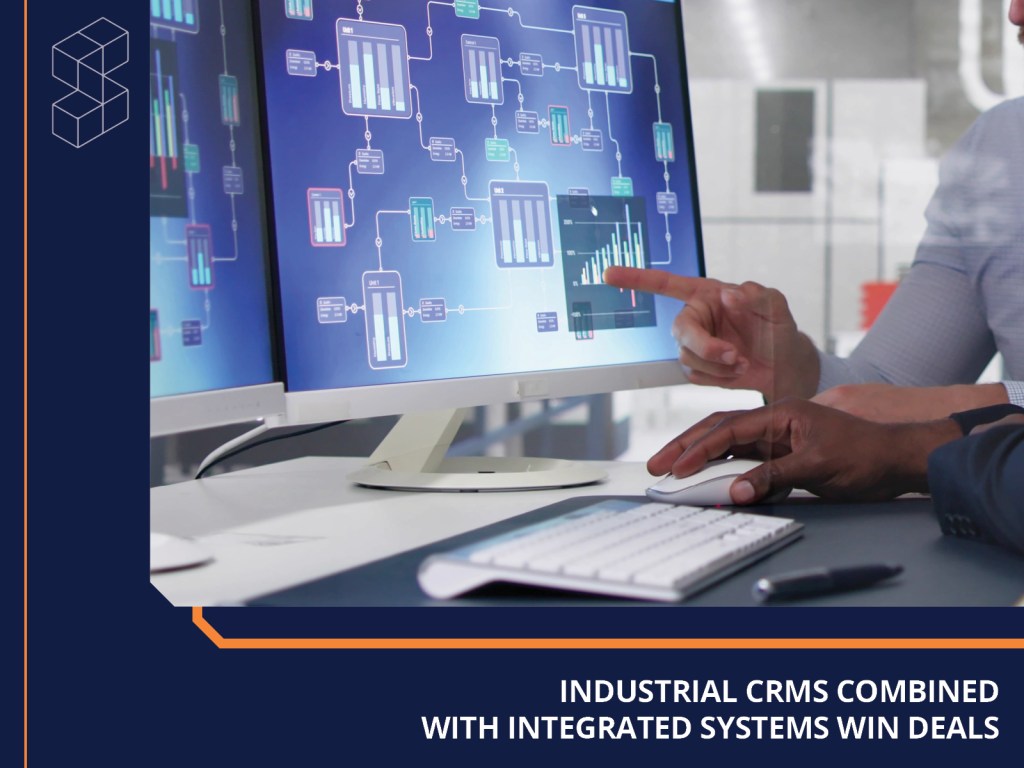 A person pointing at a computer screen displaying data analytics and workflow diagrams, emphasizing the integration of industrial CRM systems.